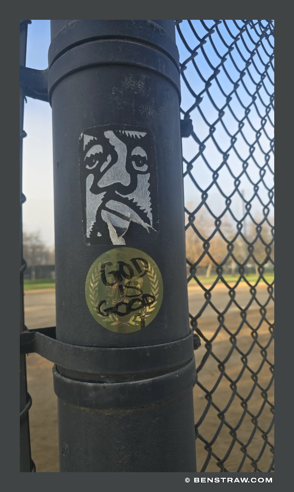 Sticker Faces on a Fence Post